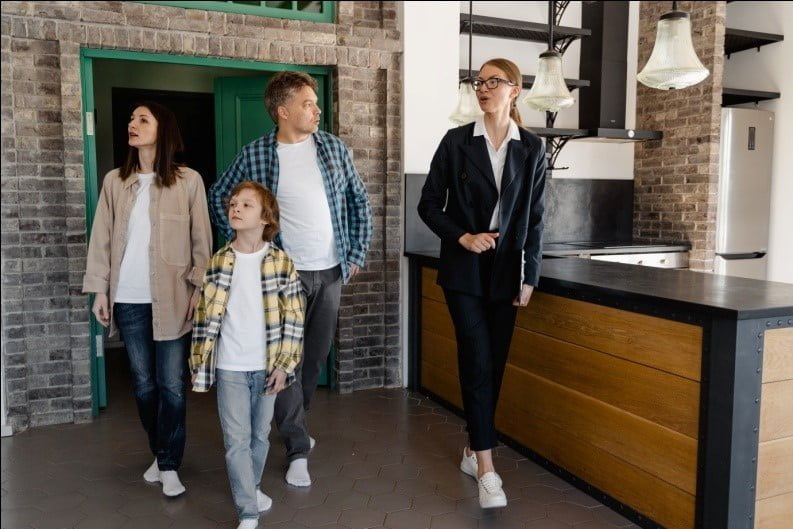 Happy family walking into their dream home - a newly built house with beautiful architecture and design. Architectural Designer analysing new build home plans and addressing common challenges to create a comfortable and functional living space.