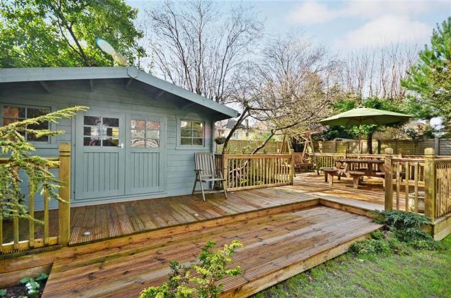 A beautifully designed backyard deck with comfortable seating, lighting, and greenery, showcasing the potential of a well-planned outdoor space.