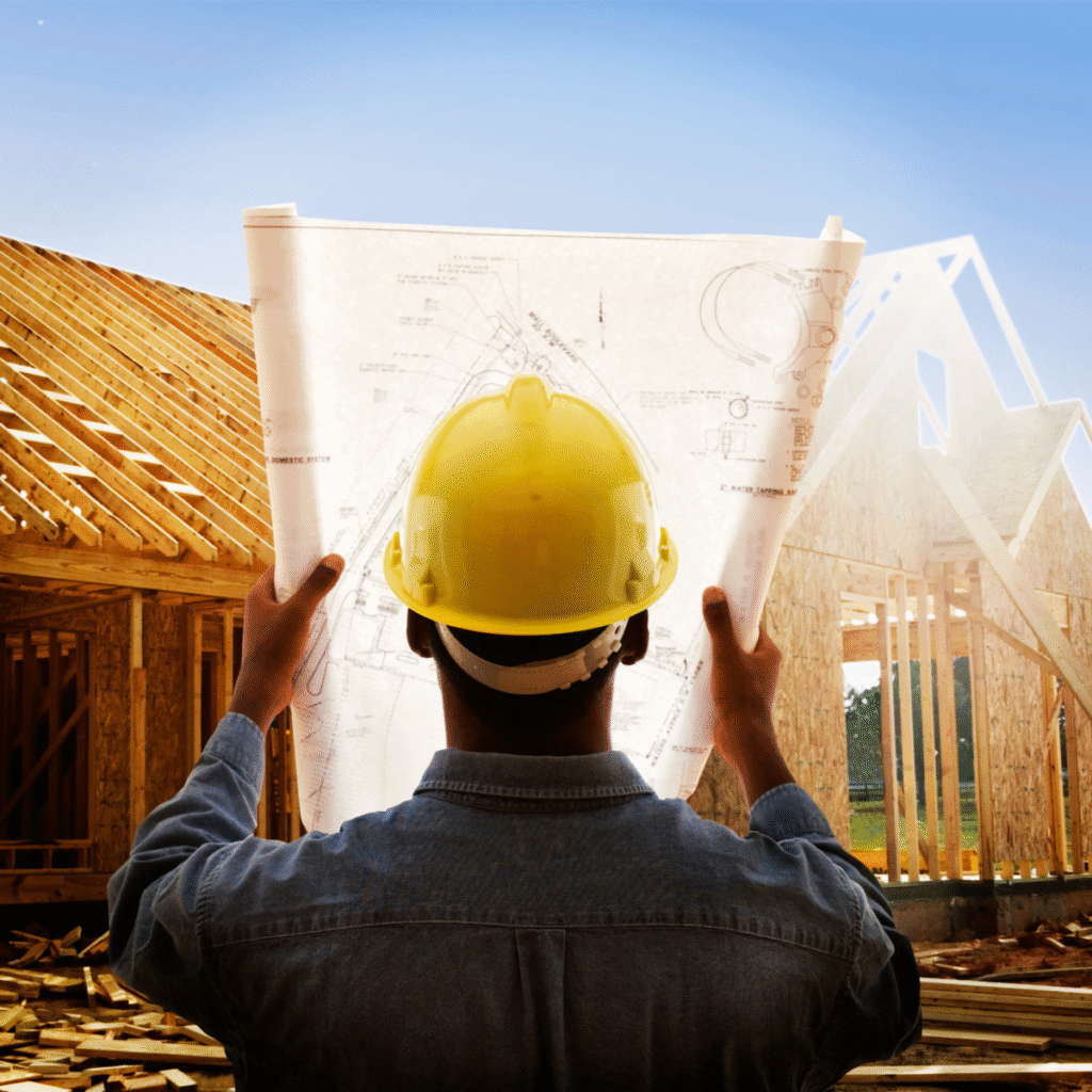 A modern house under construction, showcasing adherence to the latest UK building regulations for safety and sustainability, with a sturdy framework and the promise of a comfortable living space