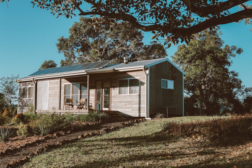 A beautiful sustainable new build home surrounded by lush greenery, showcasing innovative green building design and energy-efficient features.