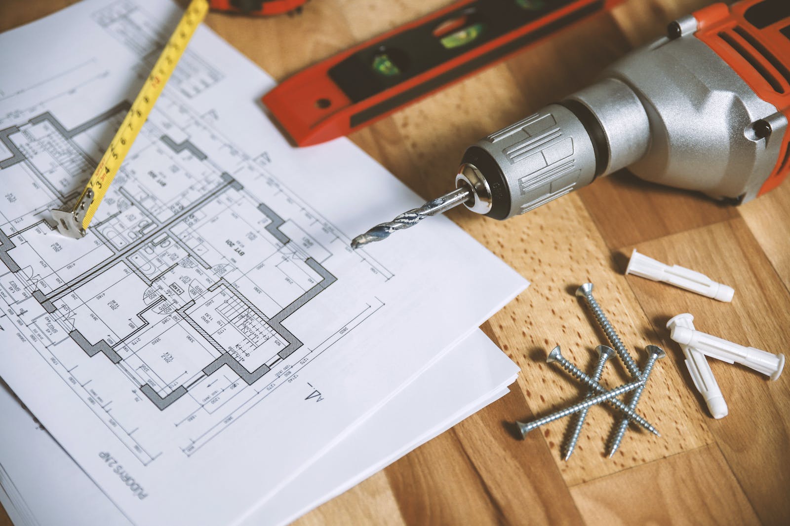 Architectural plans with a drill and ruler, ready to be reviewed for Retrospective Planning Permission by the local council