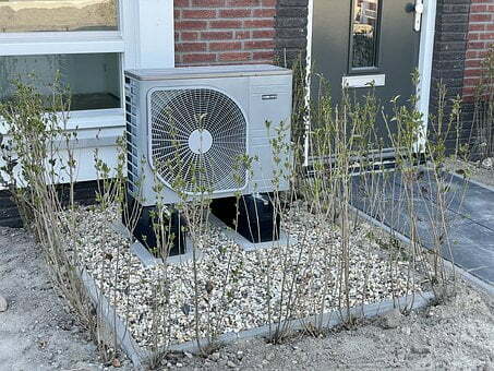 A modern home featuring an air source heat pump system, providing eco-friendly and energy-efficient heating solutions for homeowners on an architectural website.