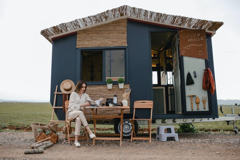 A beautifully designed modern tiny house surrounded by greenery, showcasing the charm and innovative architecture of small living spaces.