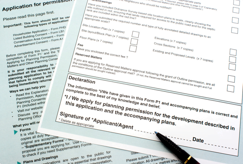 Planning Permission application forms, symbolising the importance of securing planning permission in the UK.