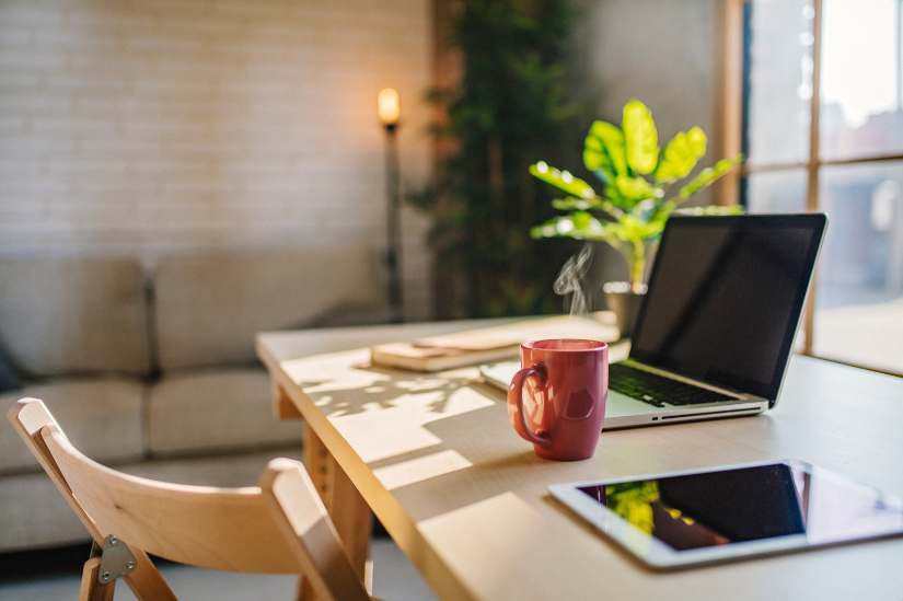 Architectural Designer working on home office design plans, showcasing considerations for space utilization, natural lighting, and ergonomic setup.