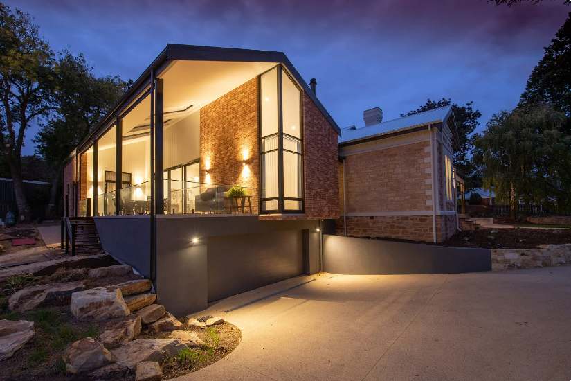 Contemporary home featuring a seamless blend of stone façade and sustainable architectural elements.